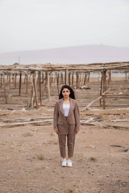 Stylish Woman Standing on Brown Soil