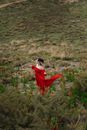 Woman in Red Dress Standing in Empty Field
