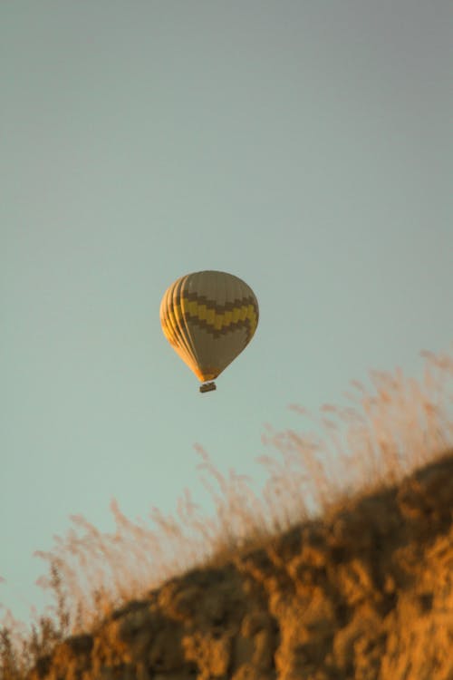 Free Yellow and Brown Hot Air Balloon in the Sky Stock Photo