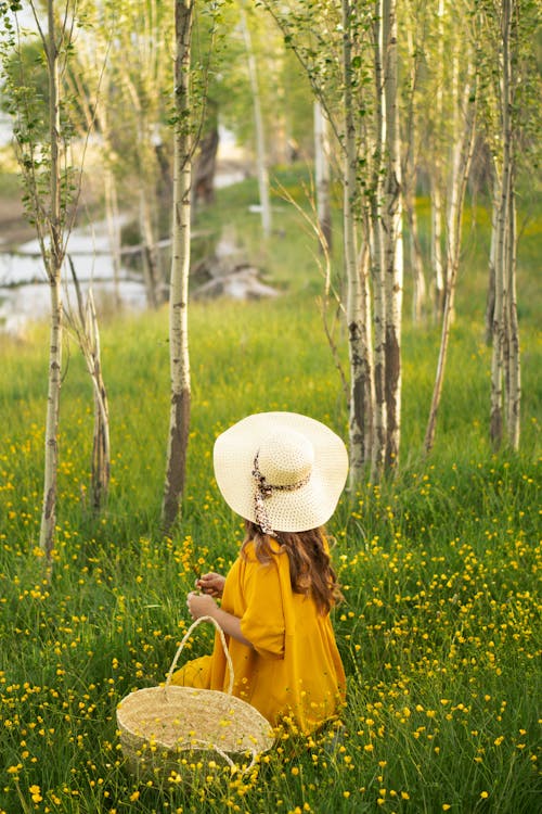 Woman in a Hat Sitting in a Meadow 