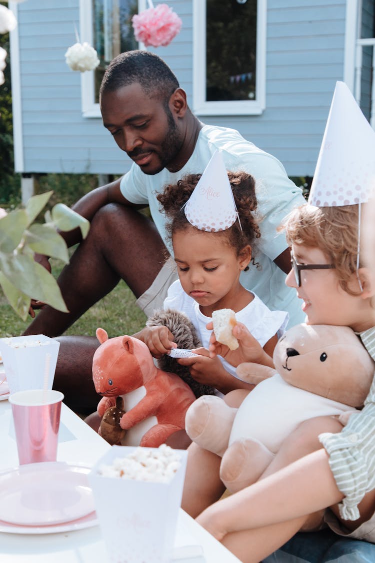 Man And Kids Sitting At Birthday Party