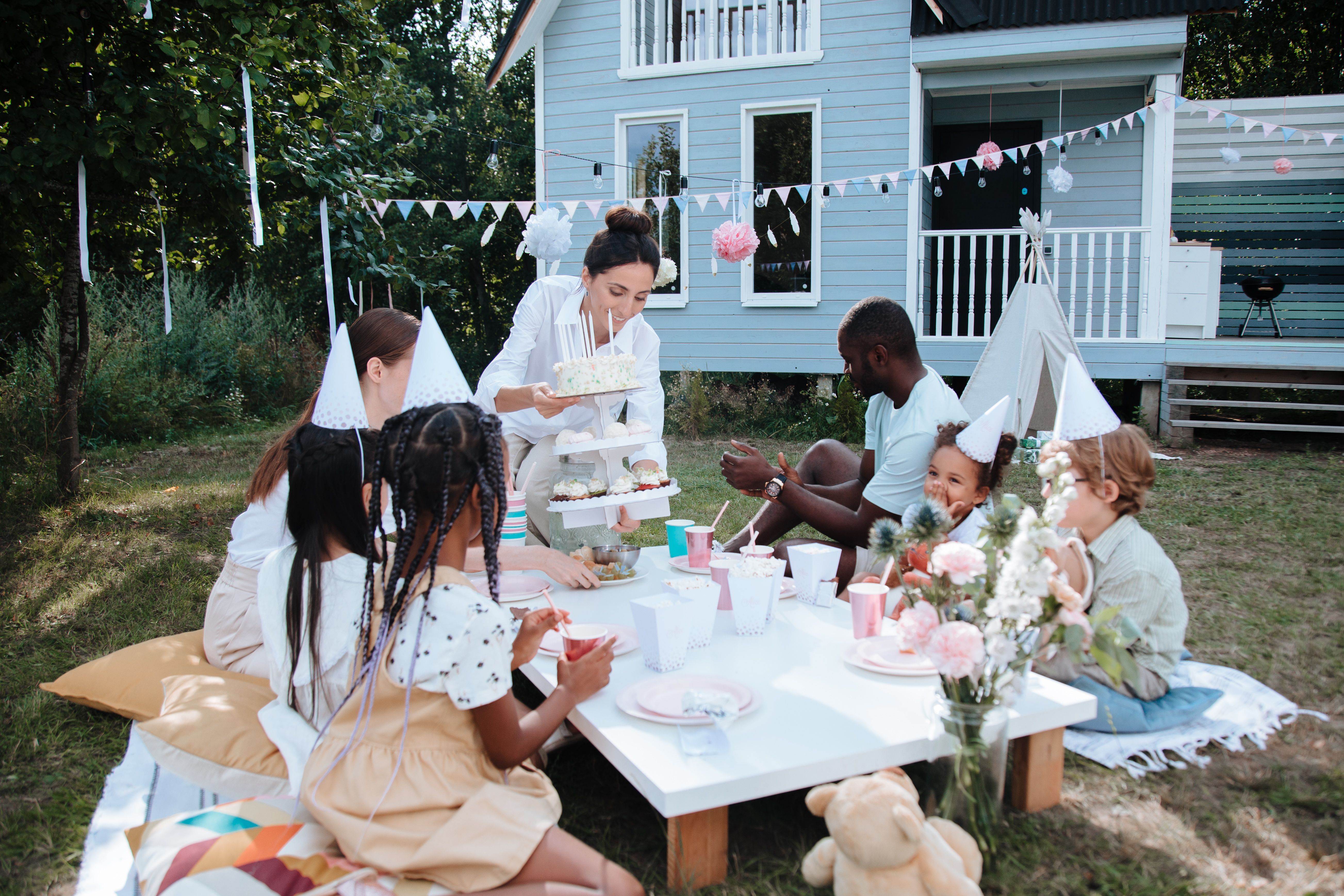Family enjoying a backyard gathering with outdoor seating and food setup
