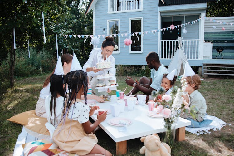 Mother Holding Cake On Birthday Party