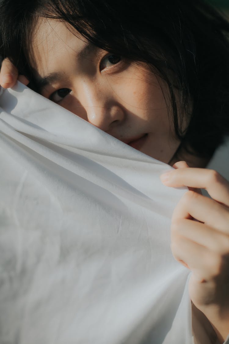 Young Woman Hiding Behind Fabric