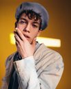 Young Man in Beret Touching Face with Hand