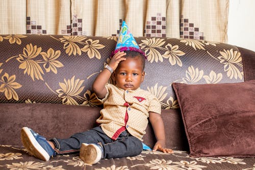 A Young Boy Wearing a Party Hat