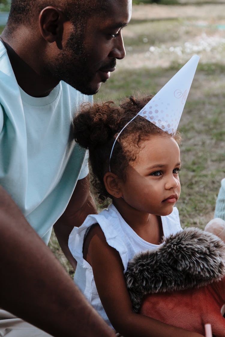 Father And Daughter At Birthday Party In Garden