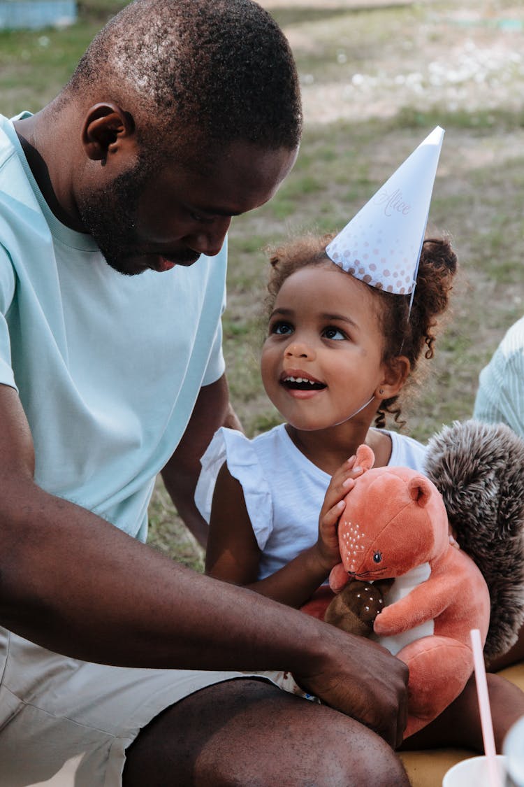 Father And Daughter At Birthday Party In Garden