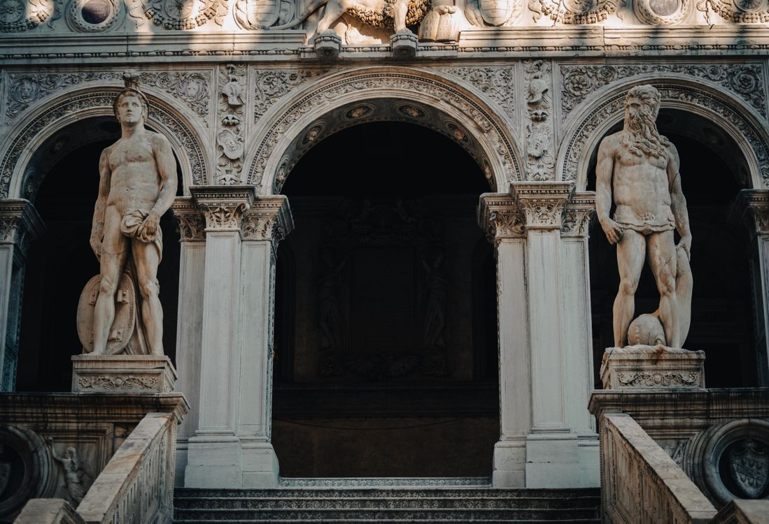 Building Posts Renaissance Sculptures in front of Renaissance Building Entrance · Free Stock Photo