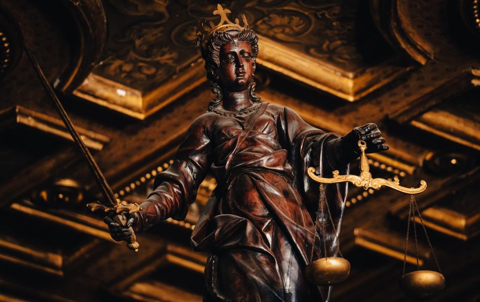 Judges gavel and legal documents on wooden desk representing burden of proof