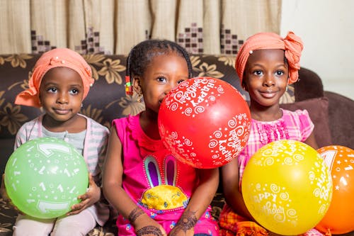 Three Girls Holding Balloons