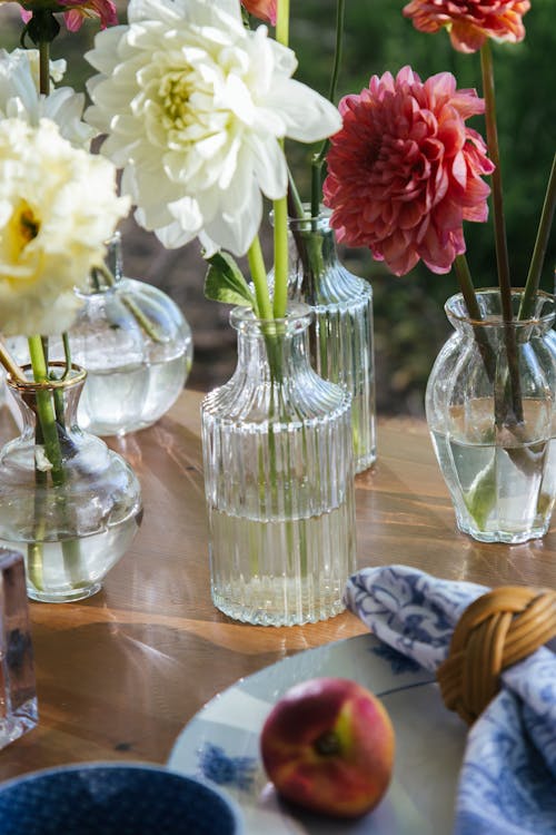 Free Fresh Flowers in Glass Vases on a Wooden Table Stock Photo