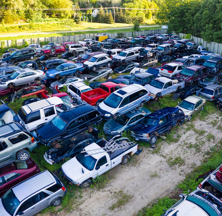 Damaged Junk Cars Parked On A Junk Yard