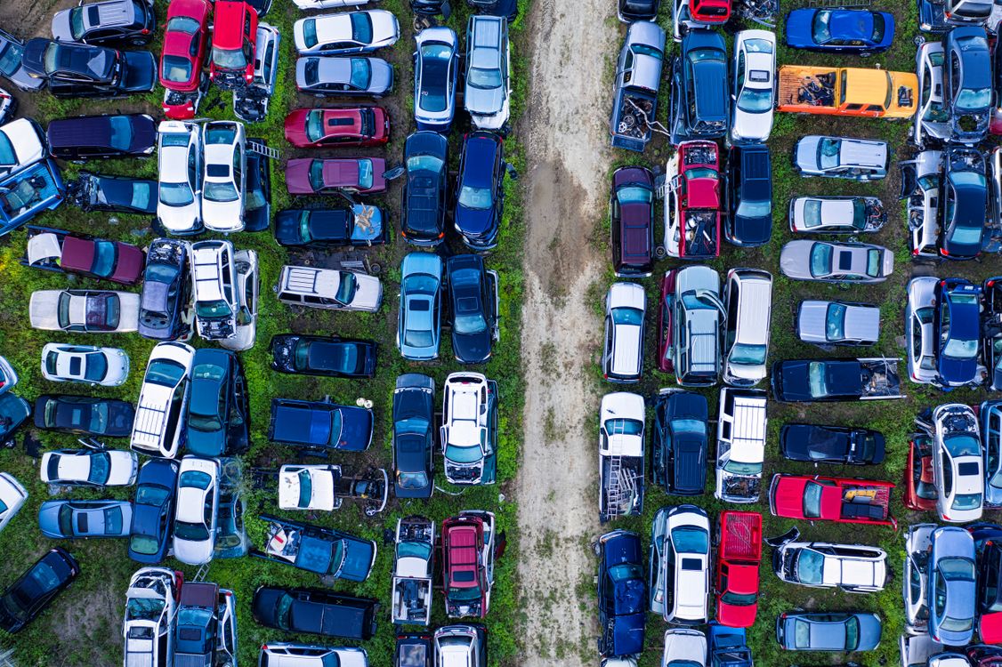 Free Aerial view of a car junkyard in Red Wing, MN, showcasing rows of parked vehicles. Stock Photo