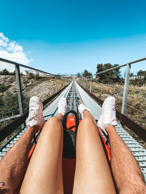 Two People Sliding on a Luge Track 