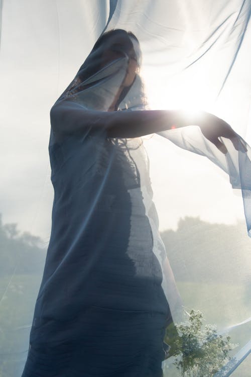 A Woman Behind a Sheer Fabric