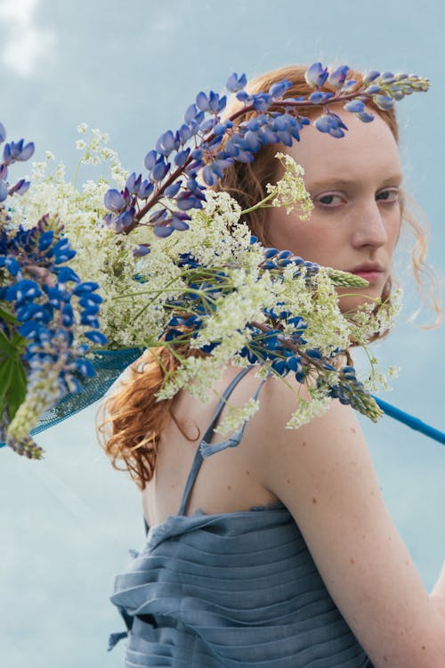 Blue and White Flowers Near a Woman's Face