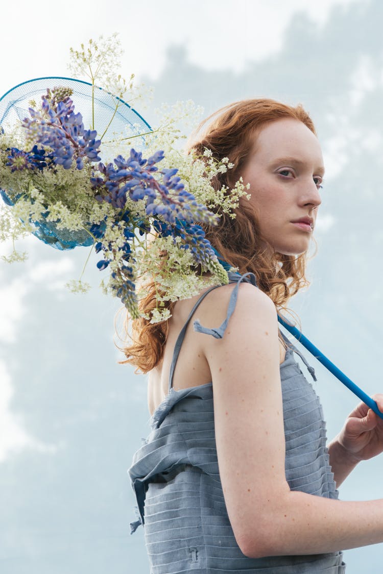 Woman Holding A Butterfly Net With Flowers