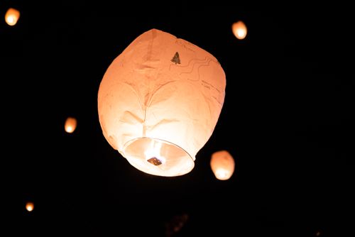 Free Captivating sky lanterns glowing brightly against the dark night sky. Stock Photo