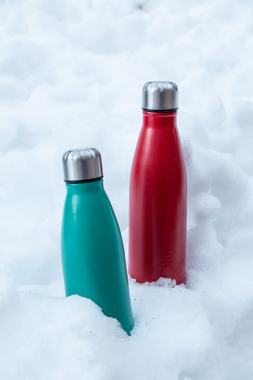 Red and Blue Bottle on Snow