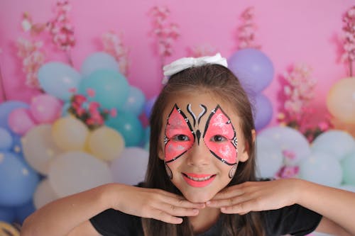 Free A Young Girl with Butterfly Face Paint  Stock Photo