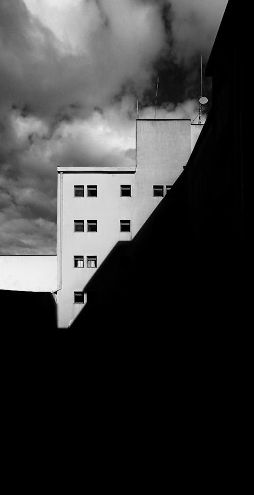 Silhouetted Part of a Building and a Block of Flats in the Background 