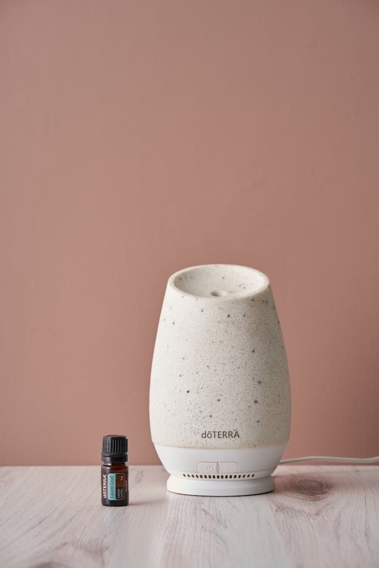 A Diffuser Beside The Essential Oil Bottle