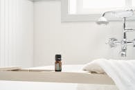 Black and Brown Bottle on White Ceramic Sink
