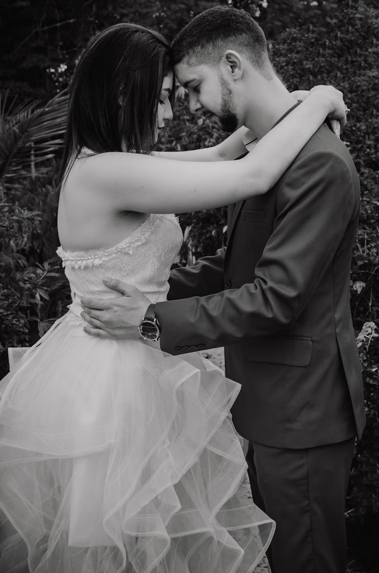 A Woman In White Wedding Dress And Man In Black Suit