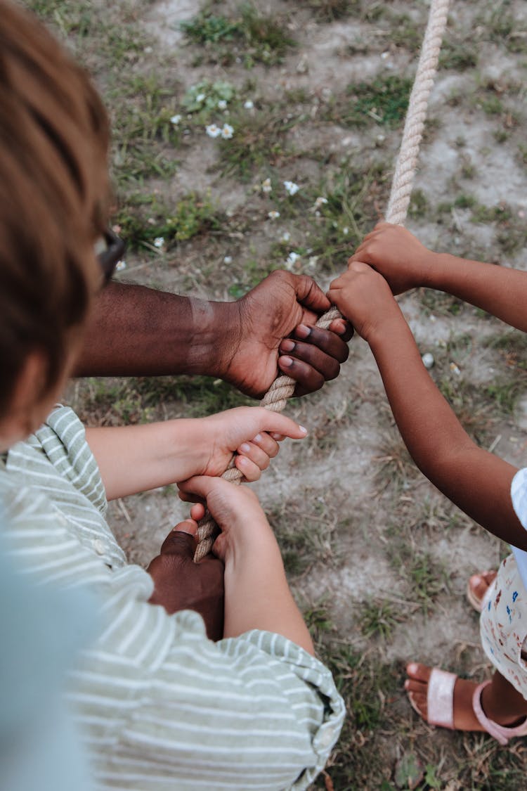 Close Up On Hands Holding Tug Of War Rope