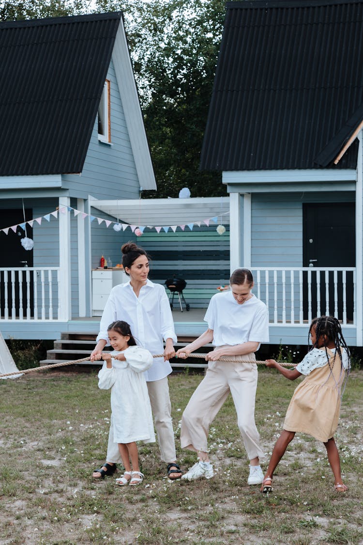 Mother Playing Tug Of War With Daughters