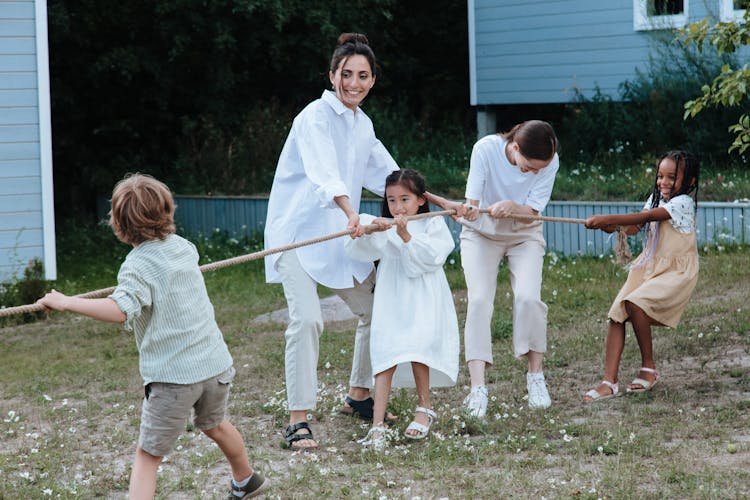 Family Enjoying Playing Tug Of War