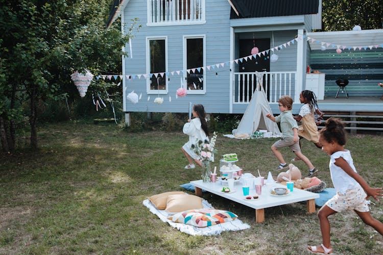 Kids Running To Pinata On Tree