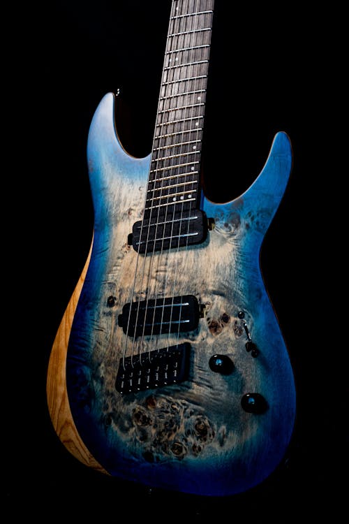 Close-Up Photo of a Blue and White Electric Guitar
