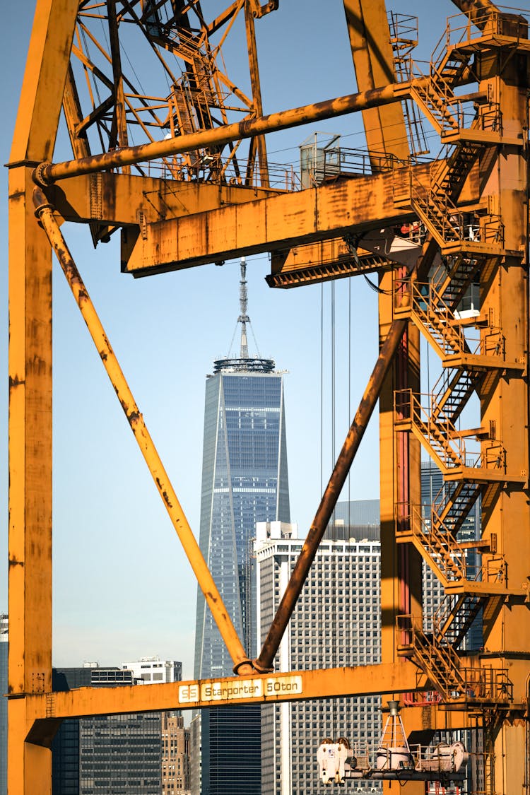 Yellow Crane Harbor Crane Near City Buildings