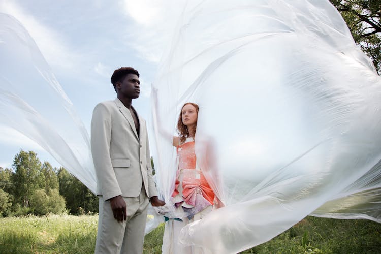 Man And Woman Holding Clear Plastic