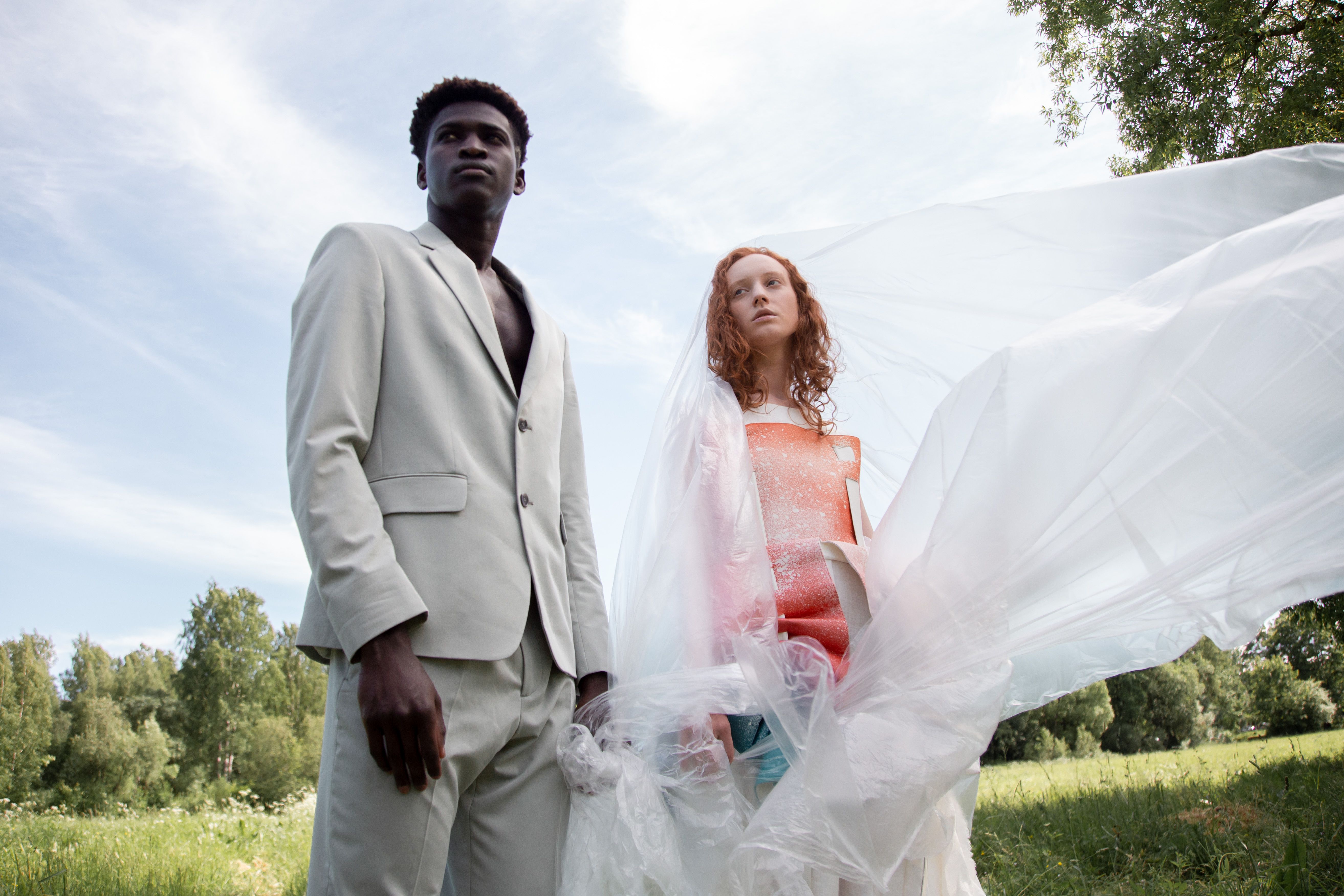 Fashion models posing outdoors with creative conceptual styling.