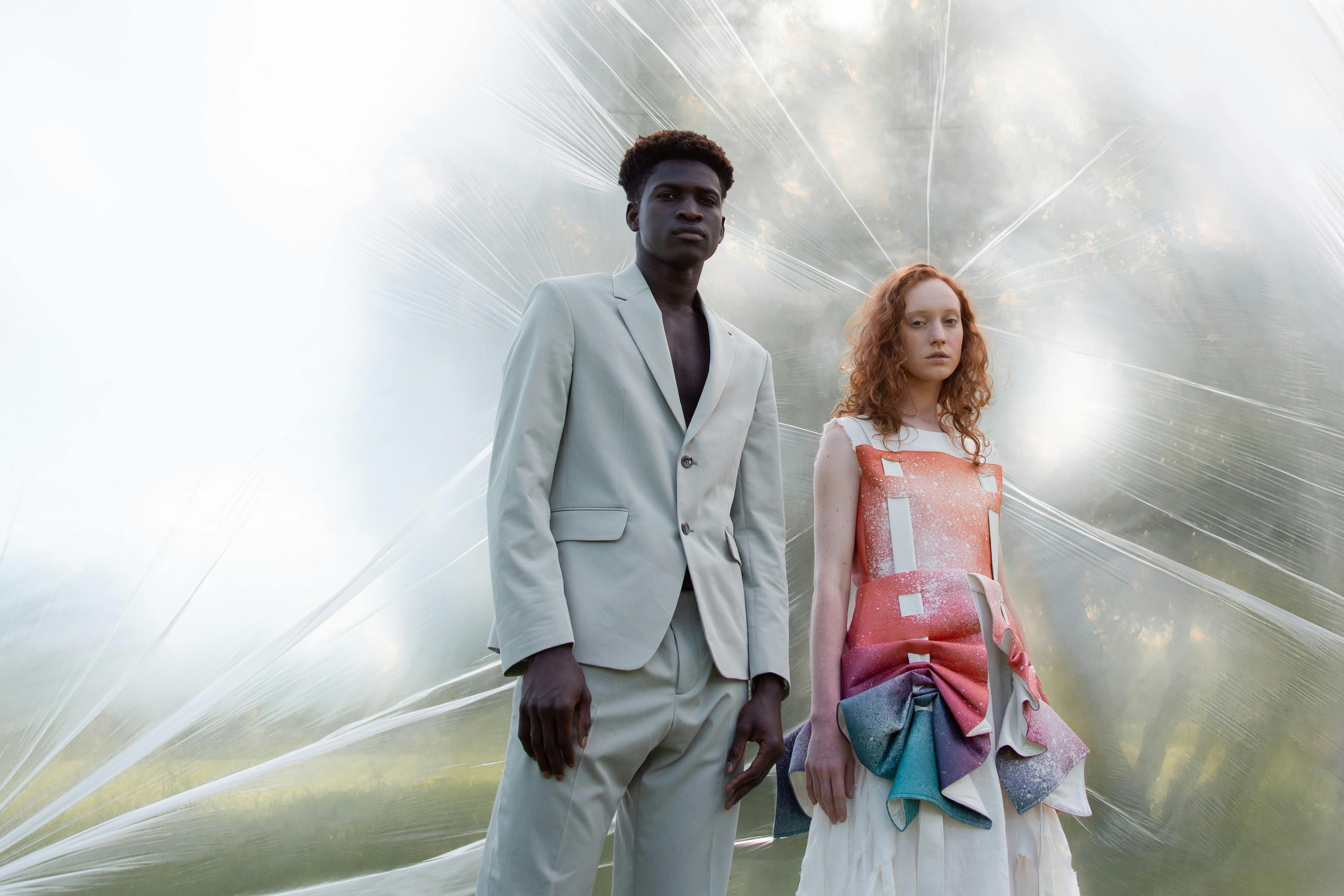 Artistic shot of stylish young models posing outdoors in modern fashion.