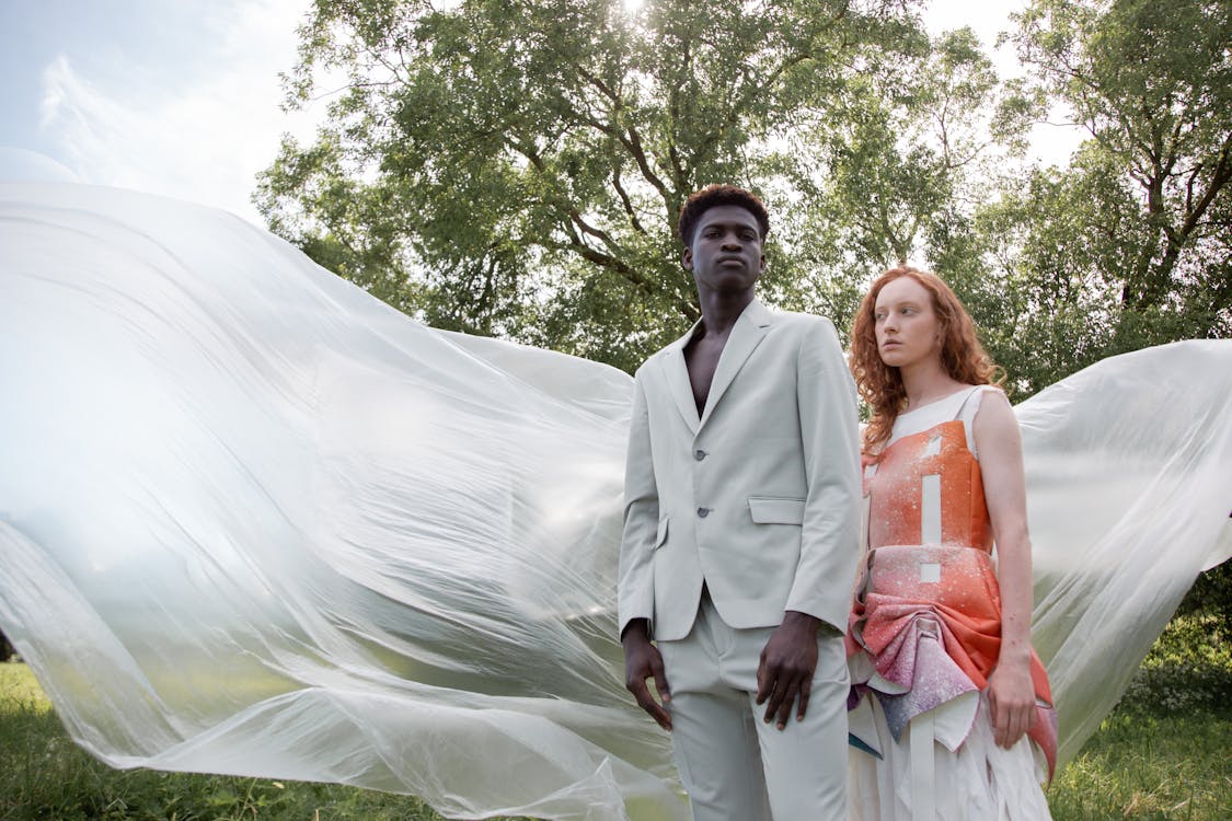 Young Fashionable Man and Woman Posing in a Park 