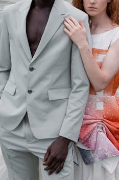 A fashionable couple dressed in a stylish suit and dress showcasing modern elegance.