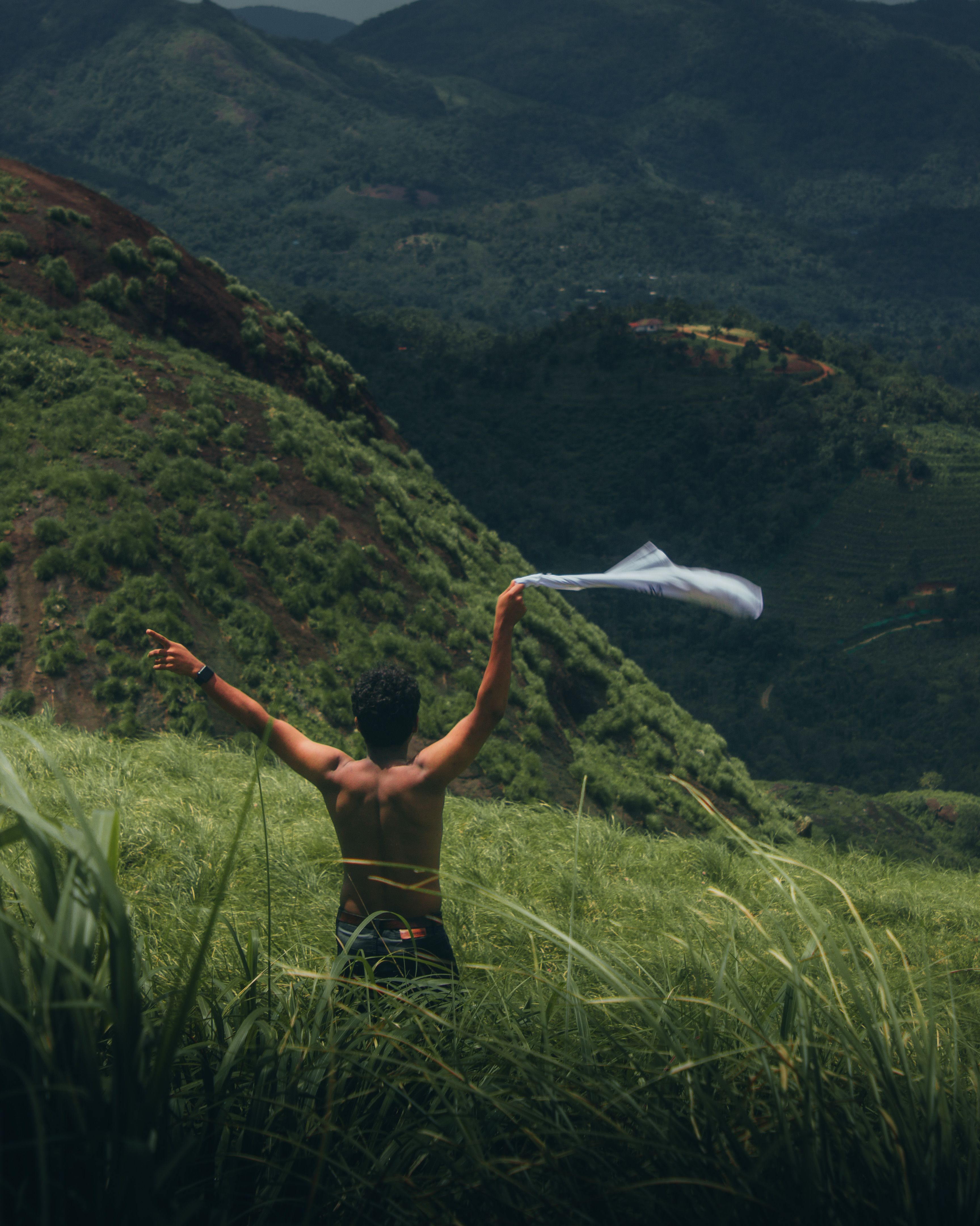 Shirtless Man Standing on Grassland · Free Stock Photo