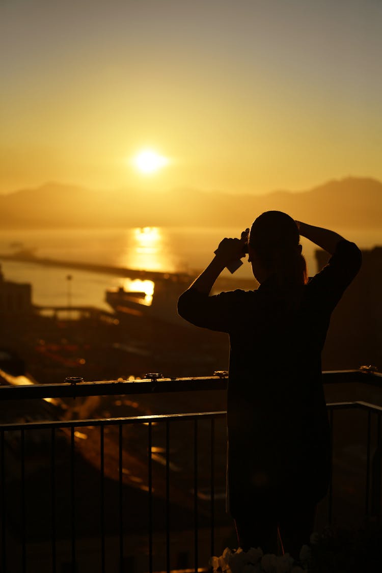 A Person Looking At A Sunset