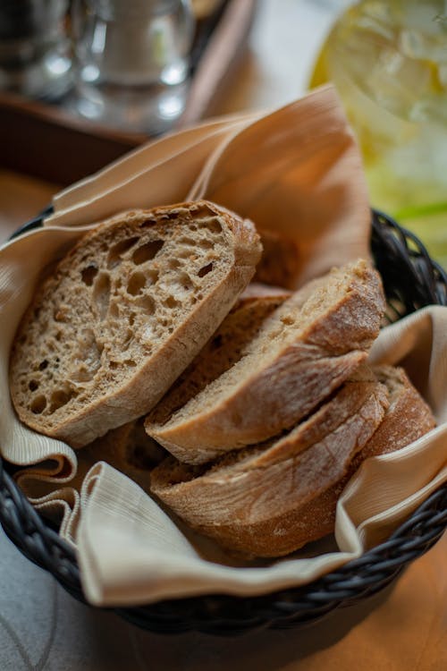 Free Slices of Bread in Green Basket Lined with Cloth Stock Photo