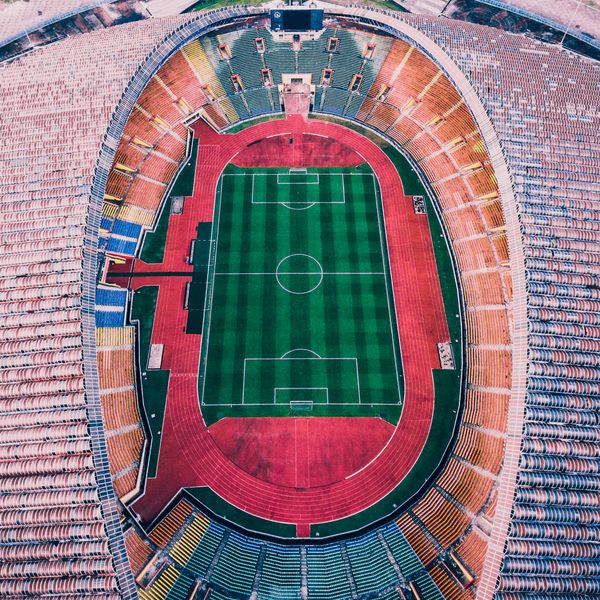 Aerial view of an empty stadium pitch and running track — photo by Deva Darshan on Pexels