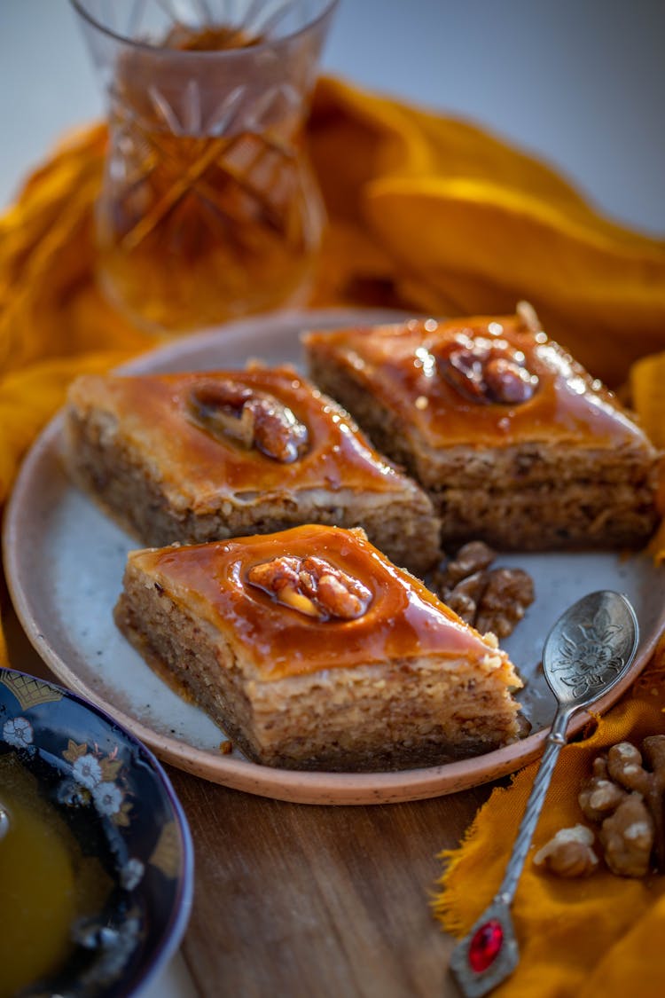 Three Baklava Diamonds On Plate With Tea Spoon