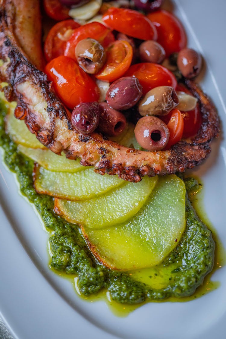 Dish Prepared Of Roast Octopus Arm With Sliced Potatoes And Pesto