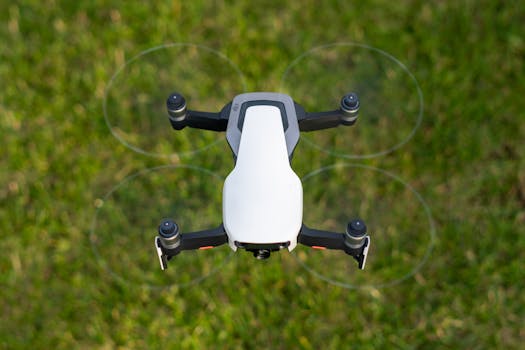 Close-up view of a drone hovering over a grassy field, captured from above.