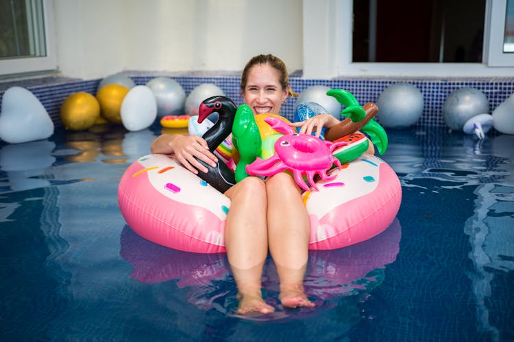 Woman In Swimming Pool With Toys