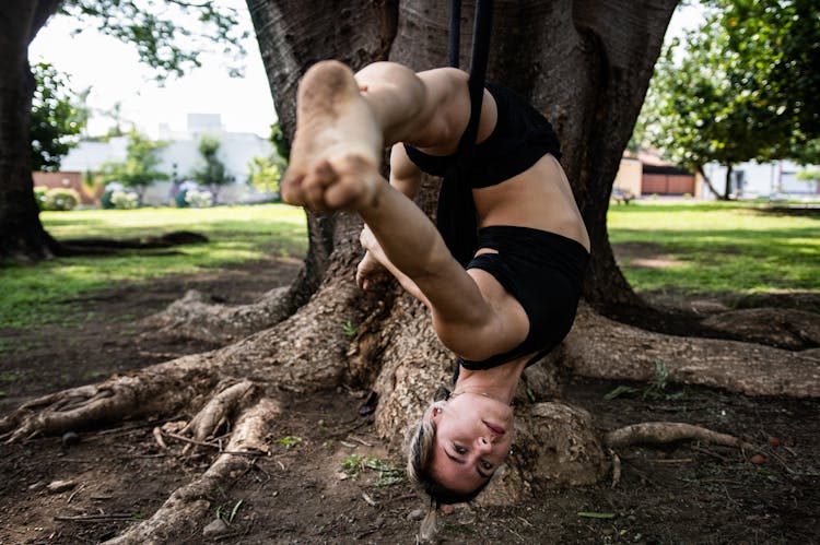 Woman Stretching On Rope In Park