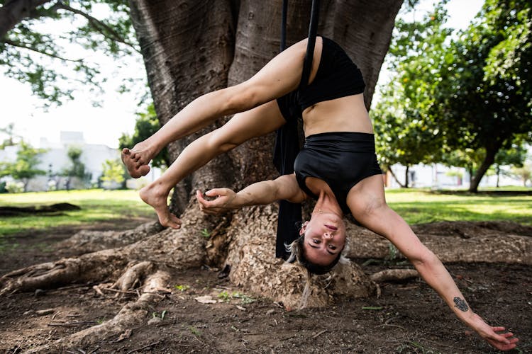 Woman Hovering On Ring Over Ground In Park